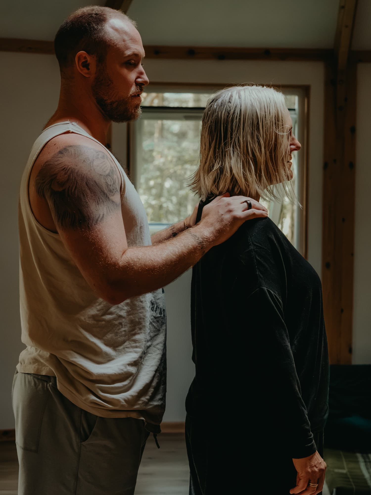 Two participants standing in facilitation, one with hands on the other person's shoulders